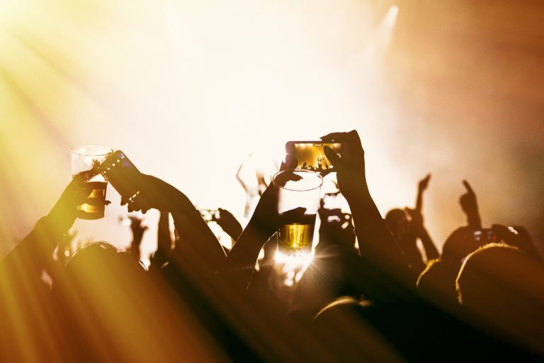 Crowds,Enjoying,Themselves,At,Outdoor,Music,Festival,,Beer,And,Smartphone